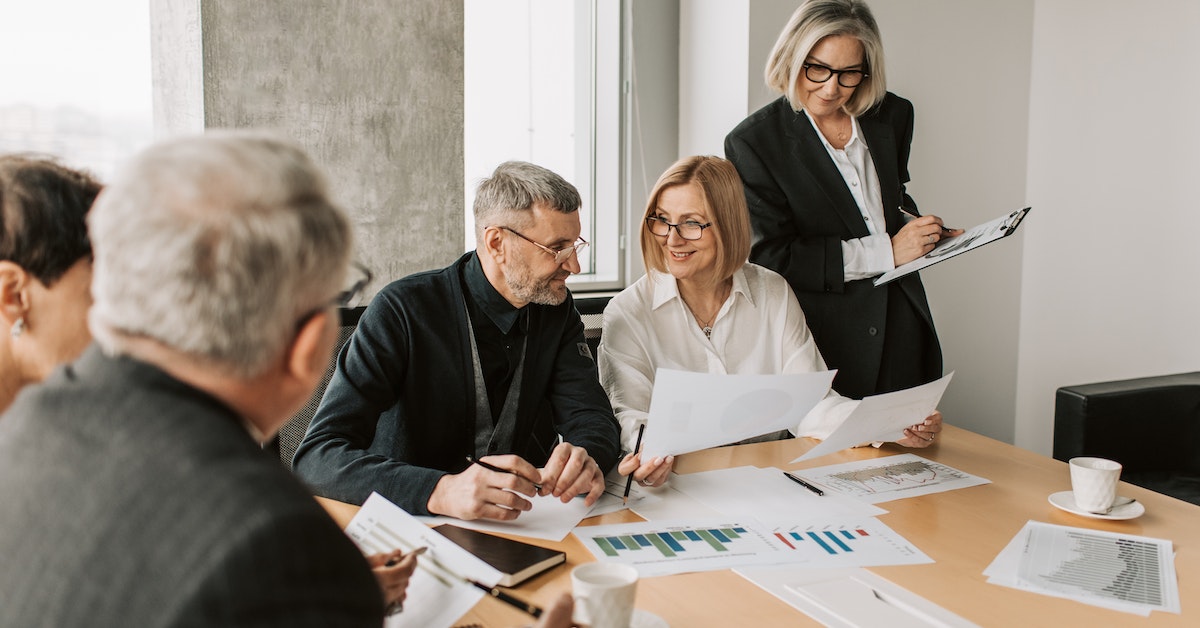 people in a corporate office discussing work